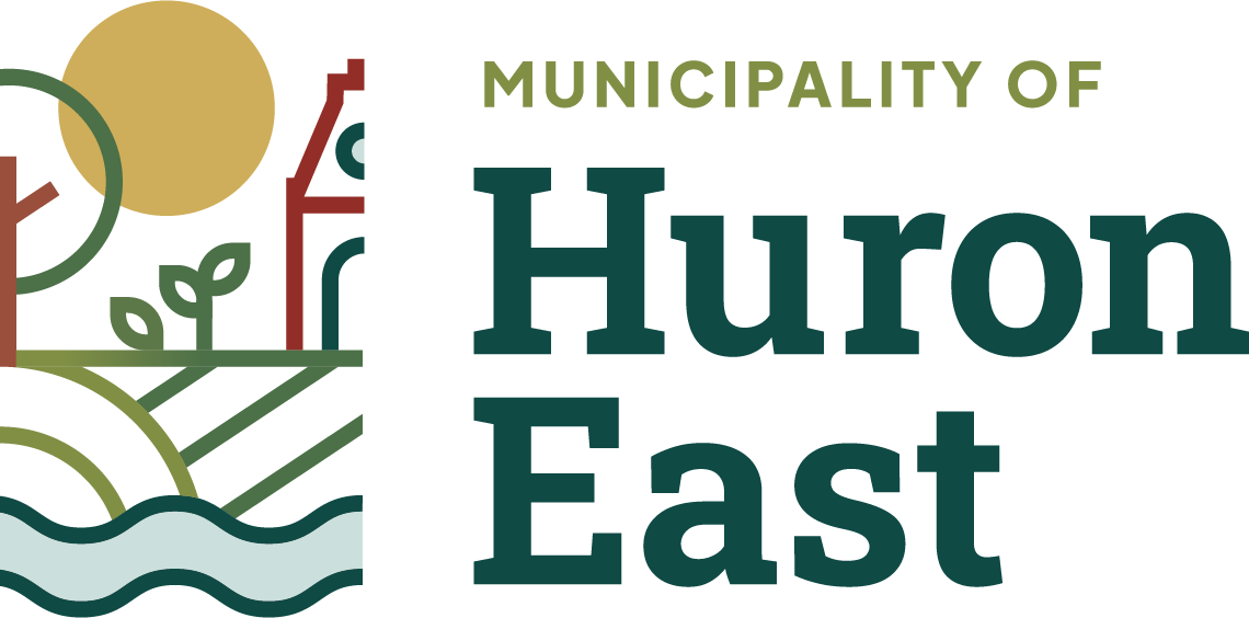 The Municipality of Huron East's new logo which shows a bell tower; tree; crops growing in the centre; a river; and fields at the bottom; and a bright sun at the top.